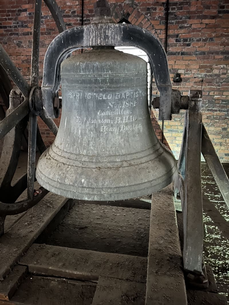 The corroded church bell in its tower before restoration, January 2026