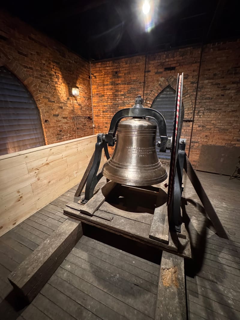 The restored bell mounted on its new frame beside the tower window
