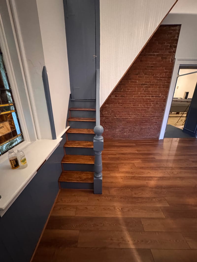 New stair to the tower with exposed brick and new flooring